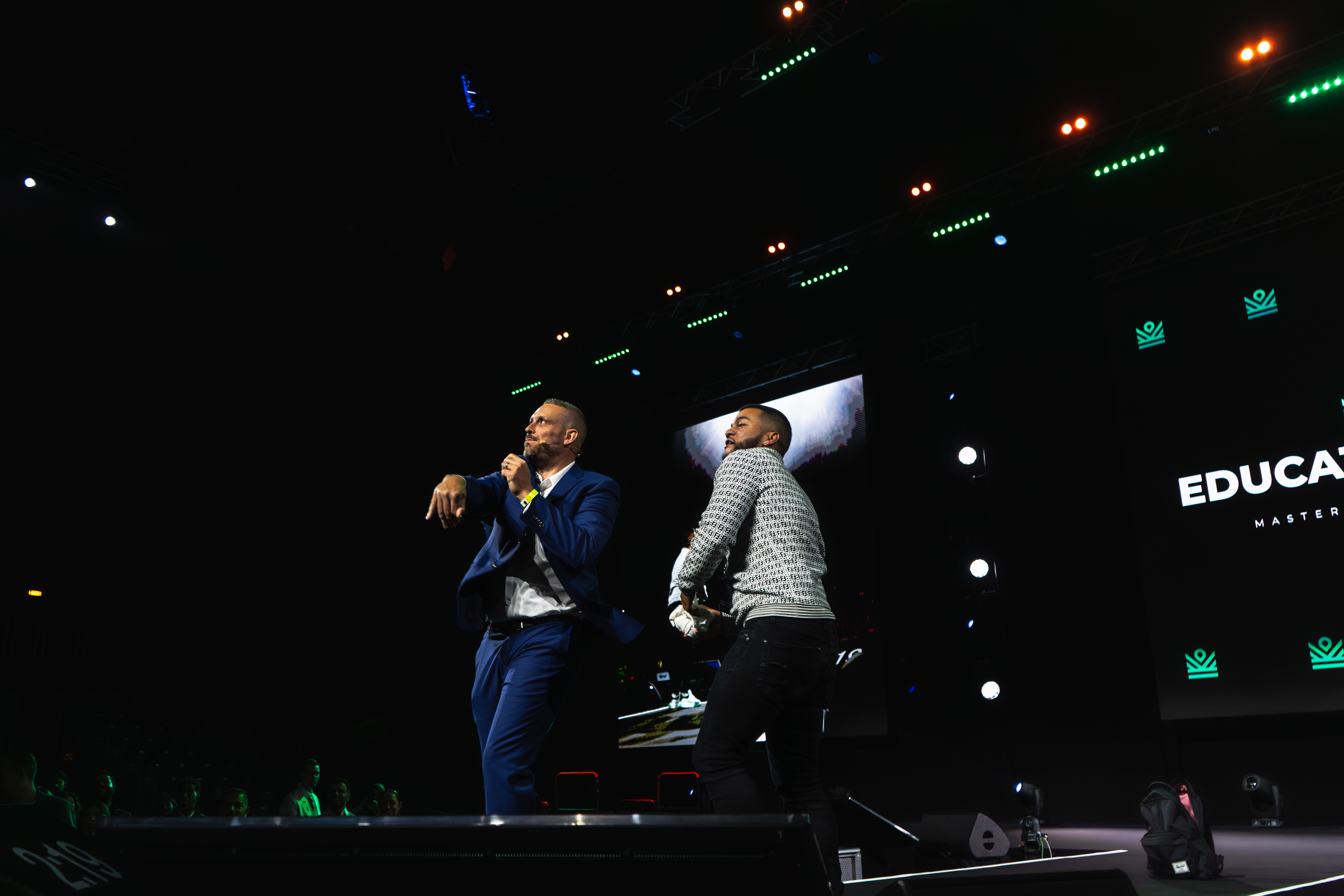 Jay on stage with a student